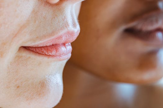 A side profile of two women's lips, highlighting diversity and skincare. Natural and smooth with a close-up focus.