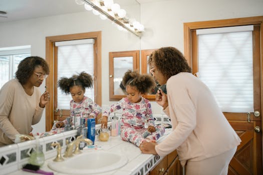 A mother and daughter engaging in a morning skincare routine together in the bathroom.