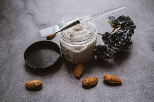 Aesthetic flat lay of organic skincare cream with almonds, ideal for wellness and beauty themes.