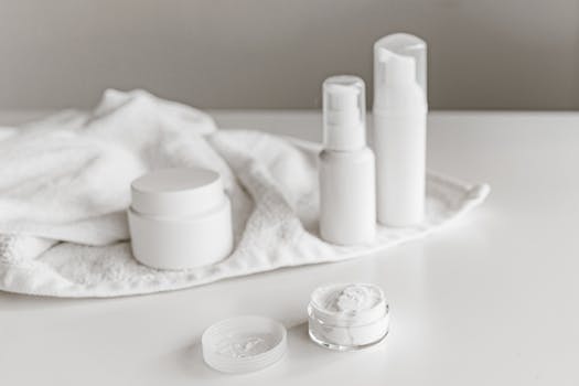 Elegant display of skincare products on a white surface, highlighting simplicity and purity.